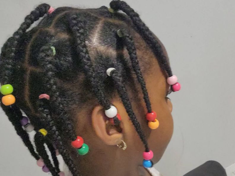 Black-children-wearing-protective-hairstyles,-including-twists, cornrows, braids,-and-buns-that-help-reduce-hair-breakage.